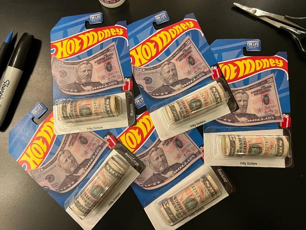 Custom carded Hot Wheels with rolls of cash in place of the diecast